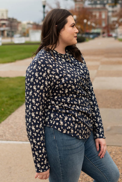 Side view of a navy flower print long sleeve top