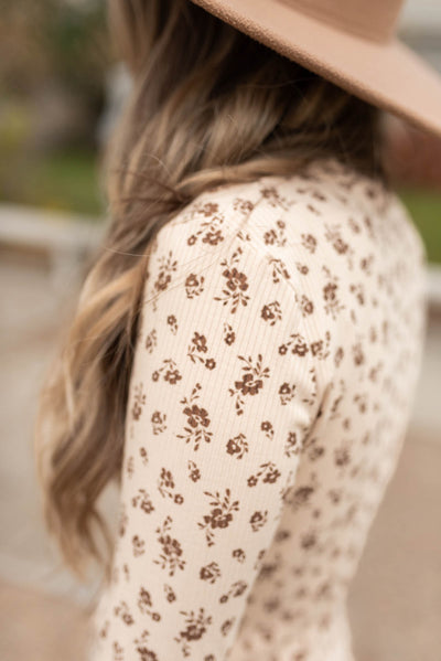 Close up of the fabric on the sand flower print long sleeve top
