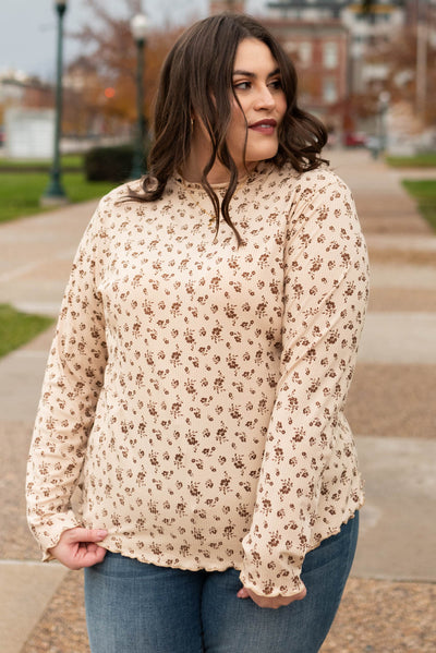 Front view of the the plus size sand flower print long sleeve top