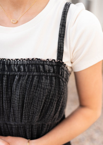 Close up of the fabric on the black cotton overall dress