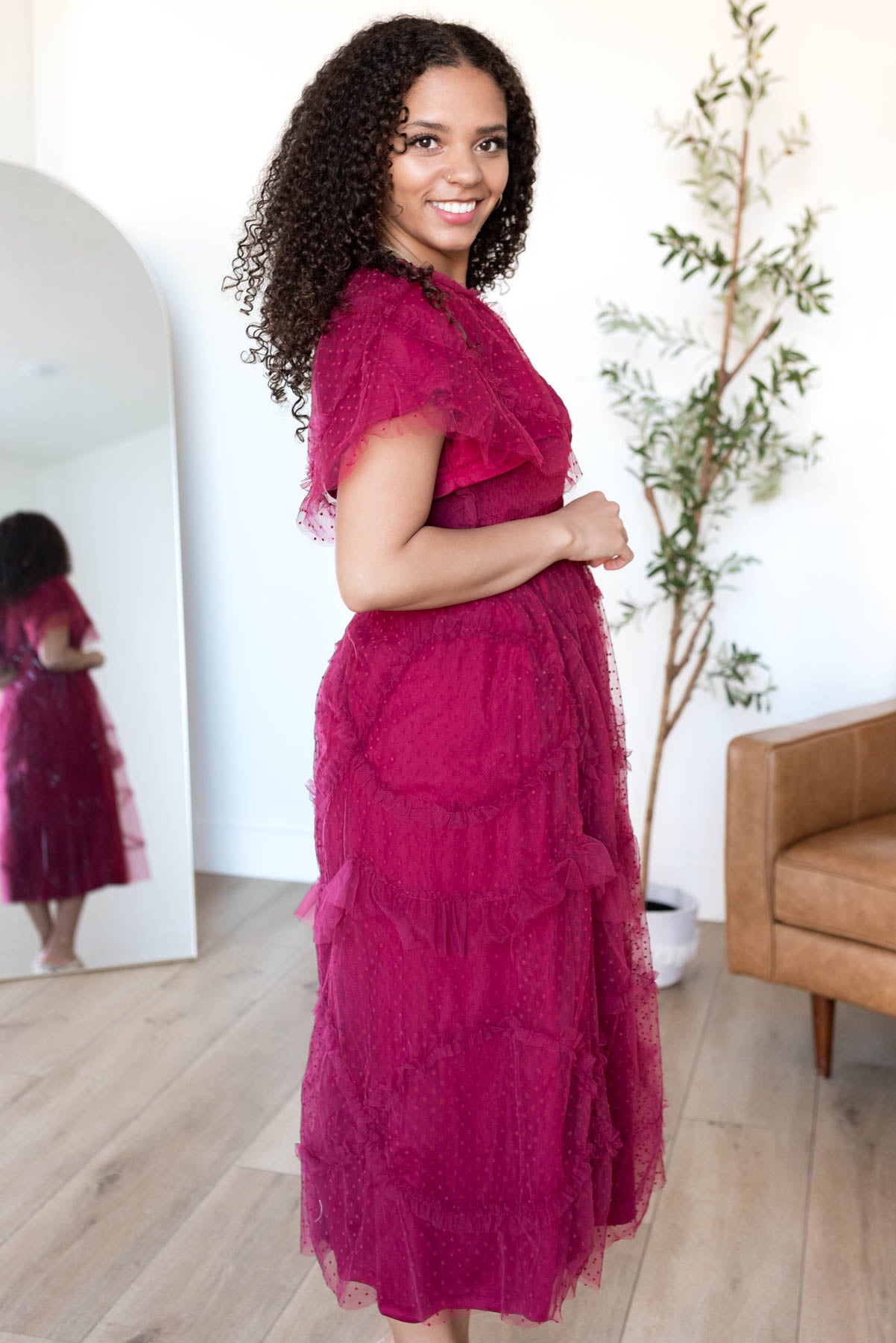 Side view of the burgundy smocked ruffle dress