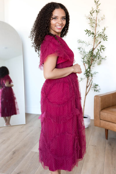 Side view of the burgundy smocked ruffle dress