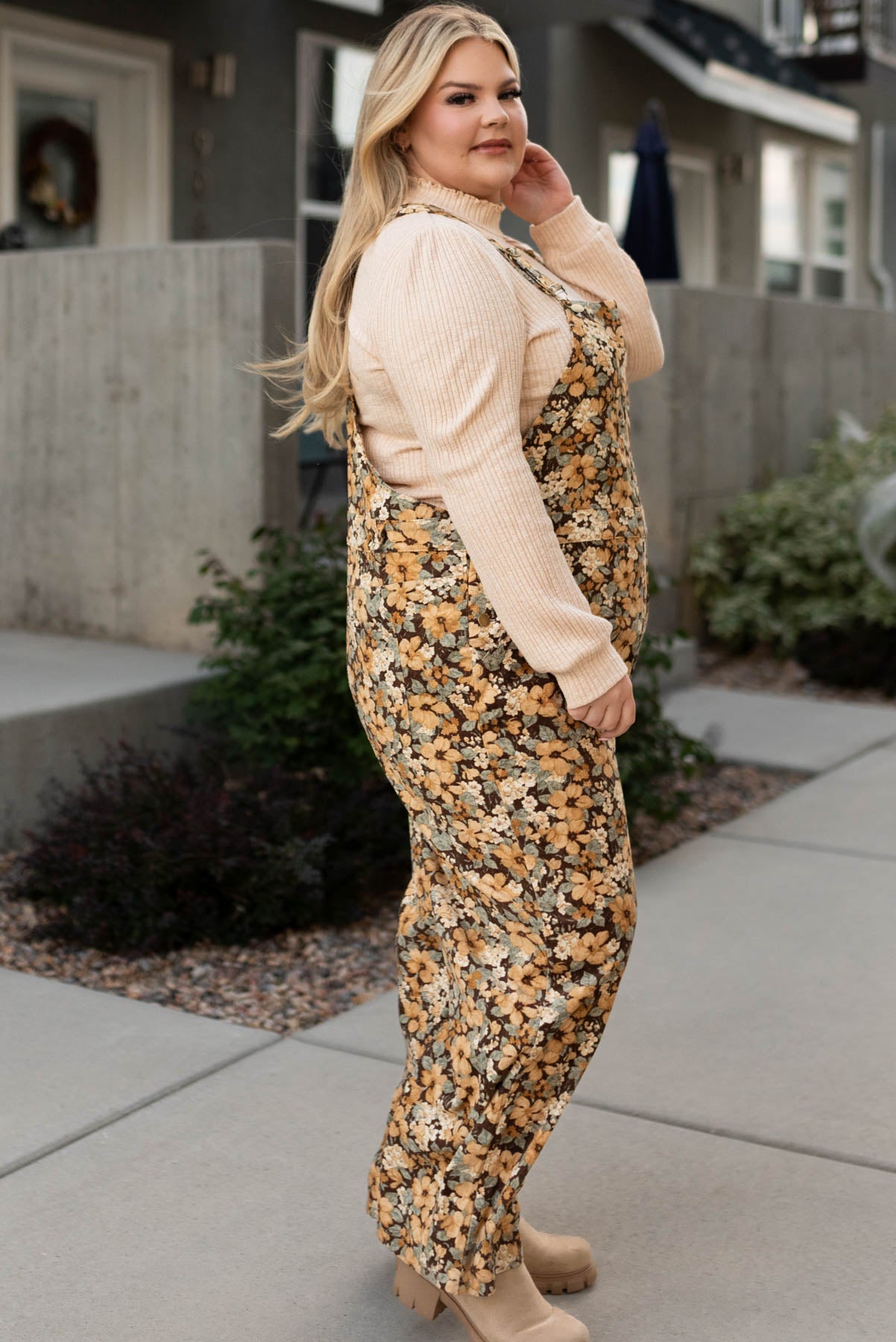 Side view of the plus size floral corduroy overalls