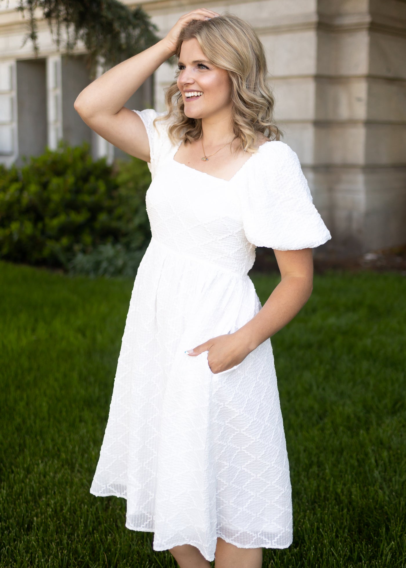 White dress with puff sleeves and square neck