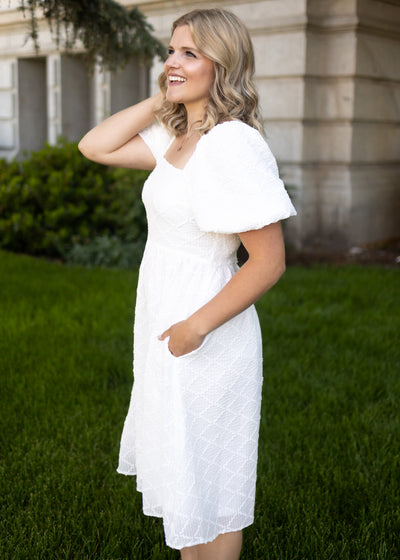 Side view of a white dress with puff sleeves