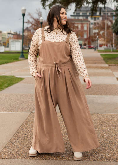 Wide leg plus size mocha jumpsuit with pockets and vegan leather straps