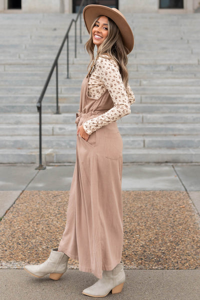 Side view of a mocha jumpsuit with pockets