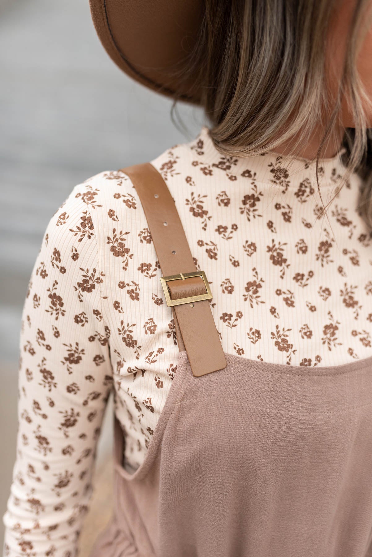 Close up of the straps on a mocha jumpsuit