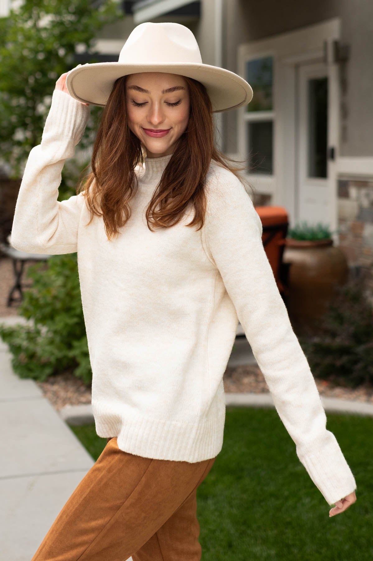 Side view of a ivory sweater