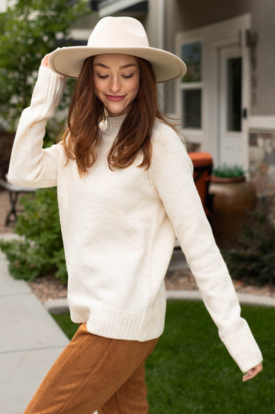 Side view of a ivory sweater