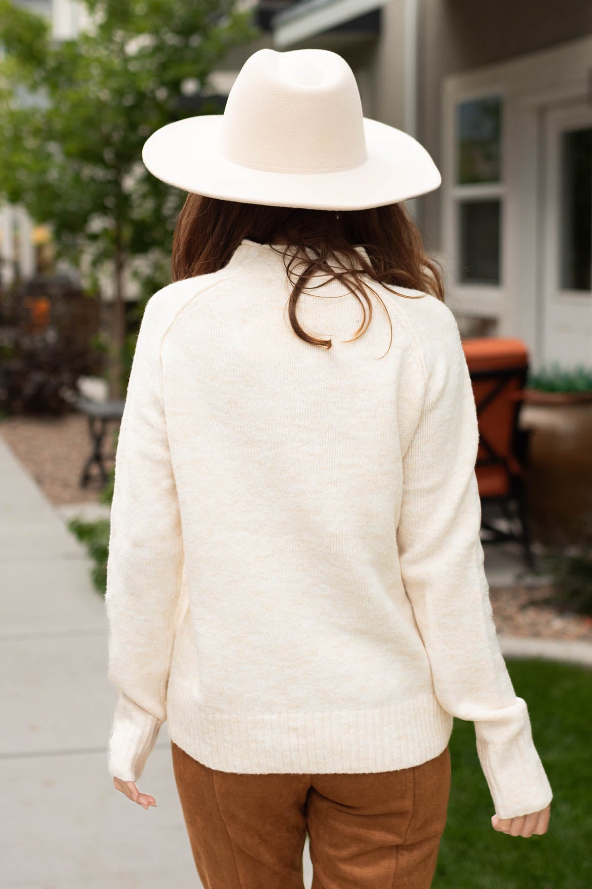 Back view of a ivory sweater