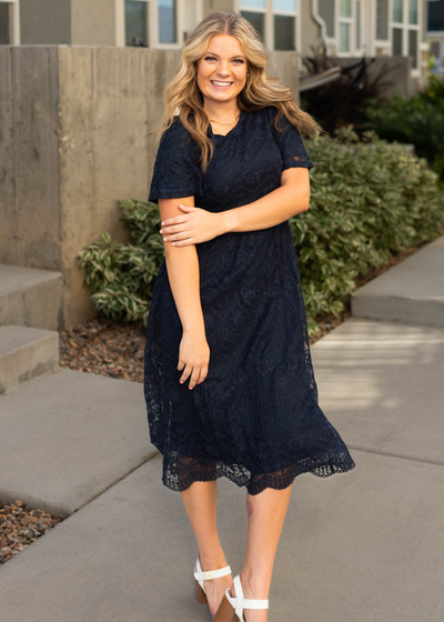 Front view of a short sleeve navy lace dress