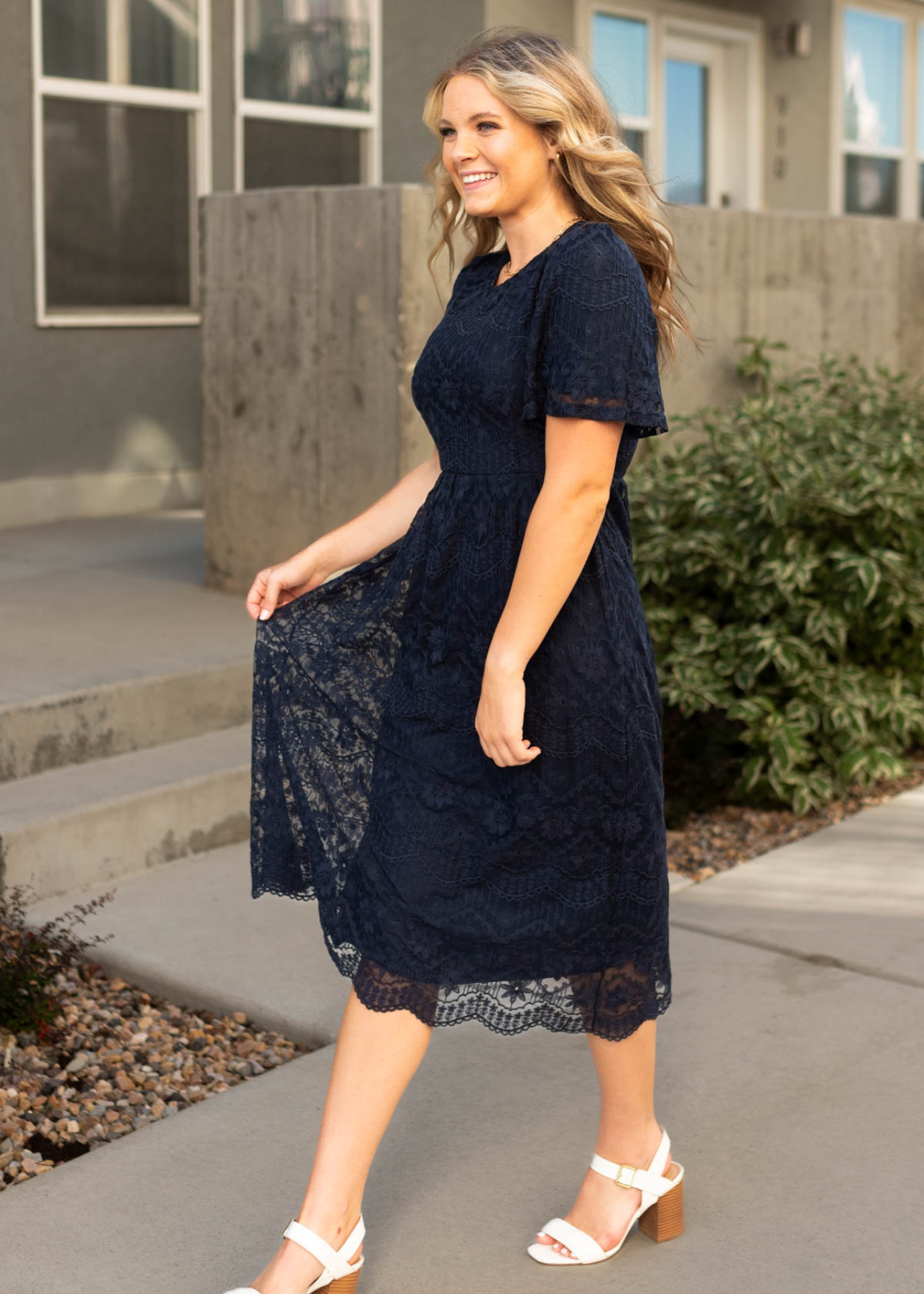 Side view of a navy lace dress