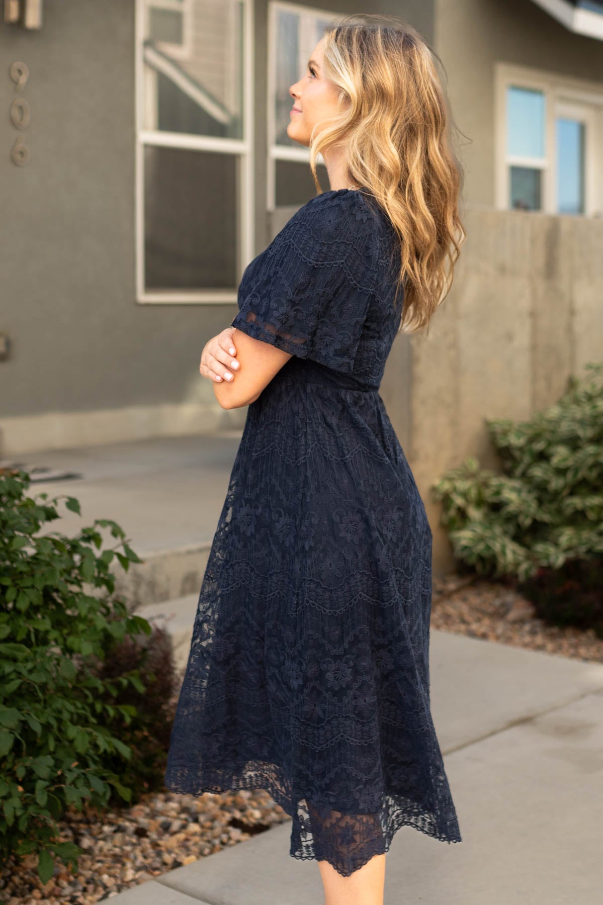 Side view of a short sleeve navy lace dress