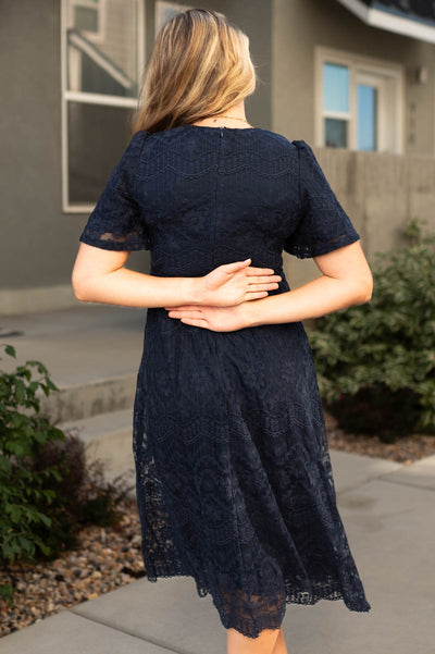 Back view of a navy lace dress
