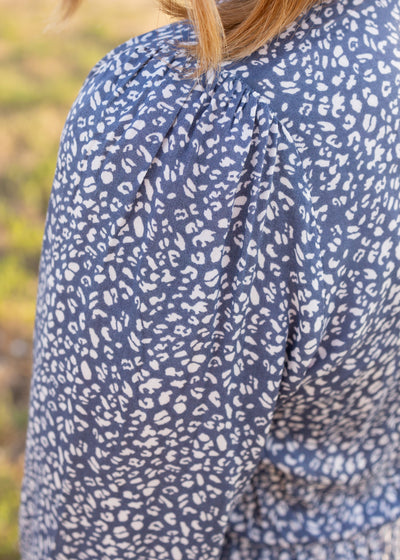 The sleeve of a blue leopard dress