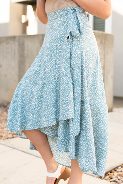 Side view of the wrap style high low blue skirt
