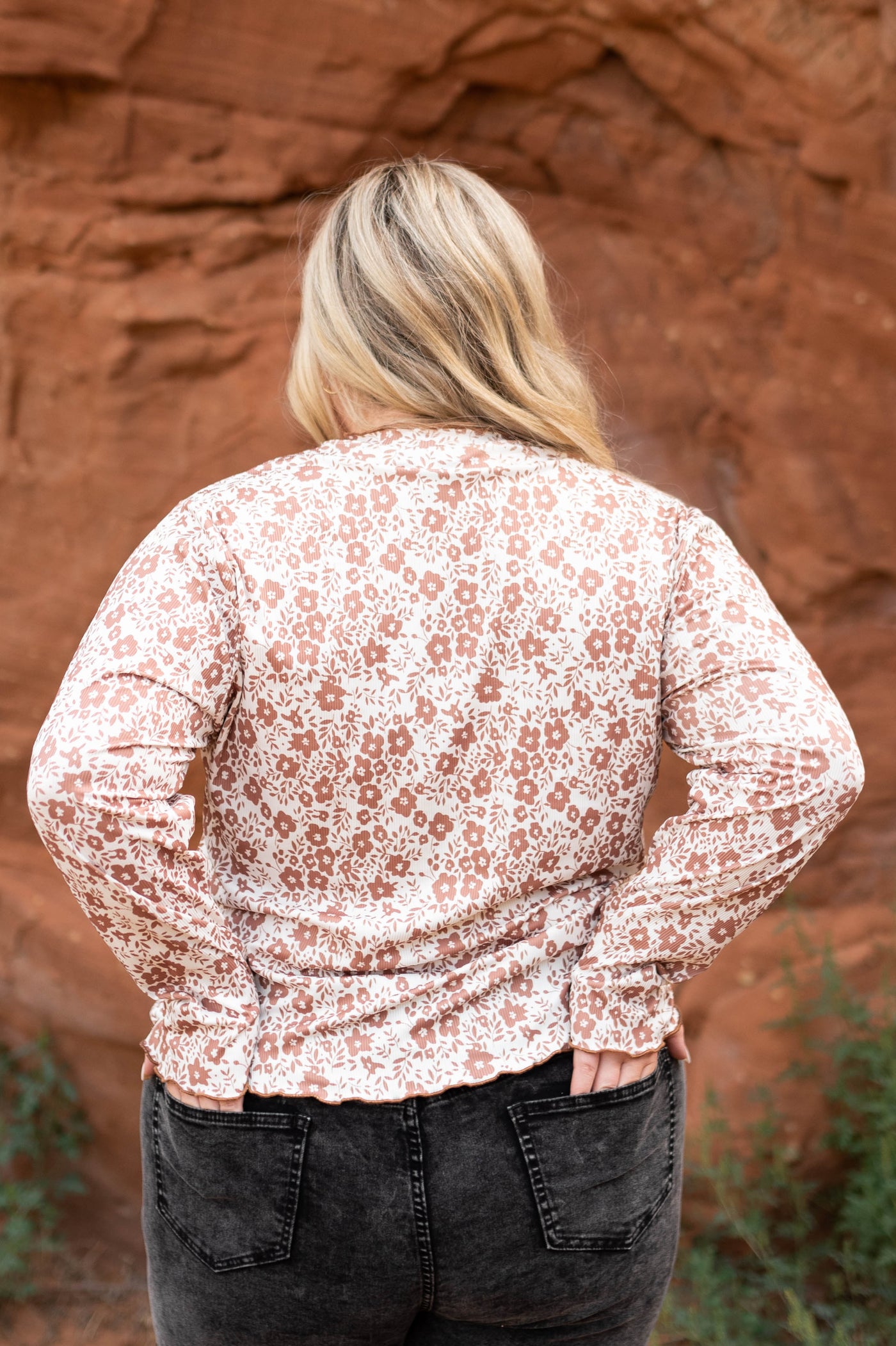 Back view of a plus size brown floral top