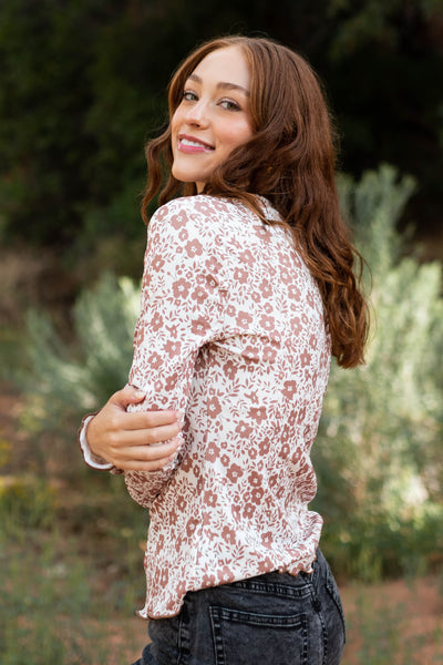 Side view of a brown floral top