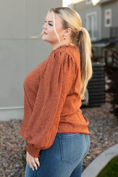 Side view of a plus size rust top