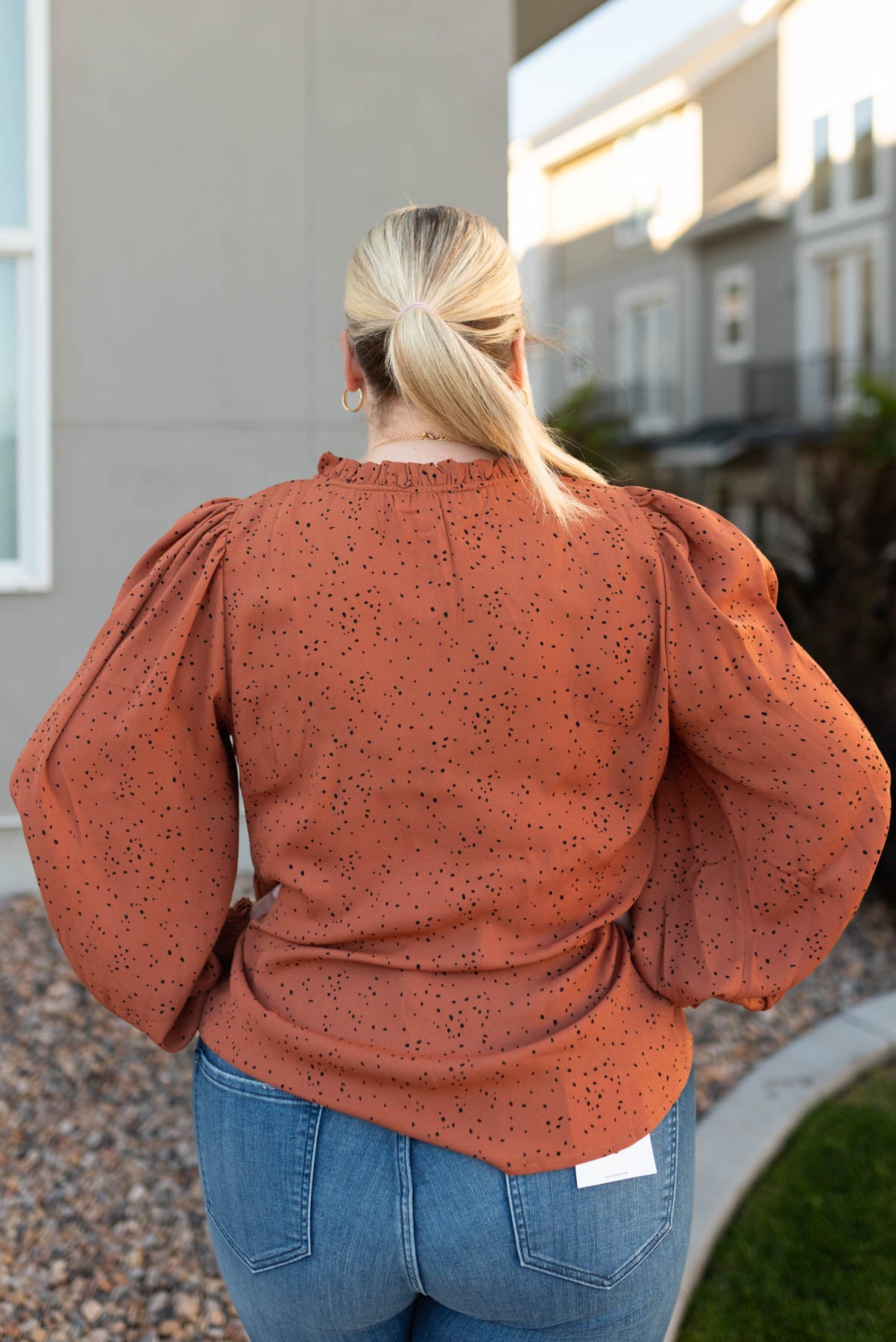 Back view of a plus size rust top