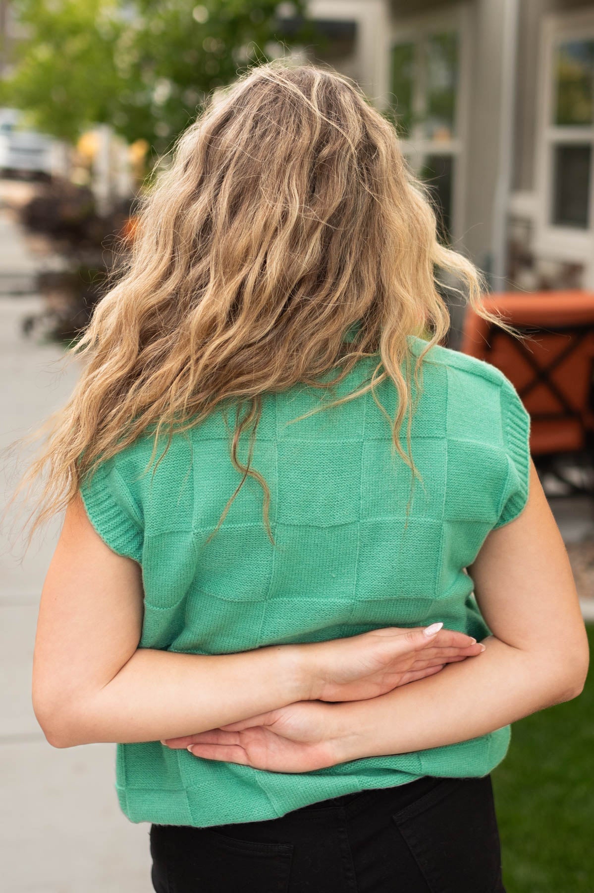 Back view of a green sweater vest