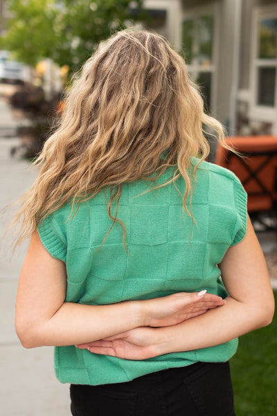 Back view of a green sweater vest