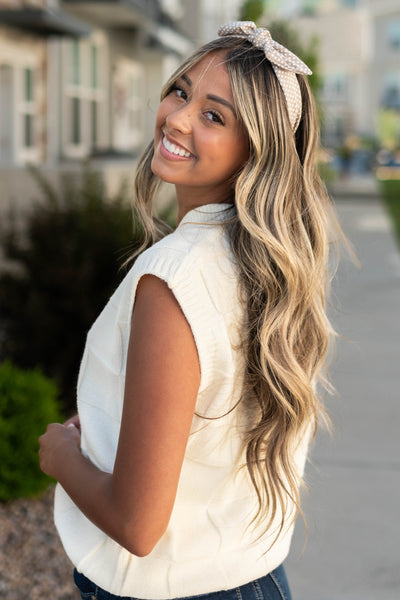 side view of a ivory sweater vest