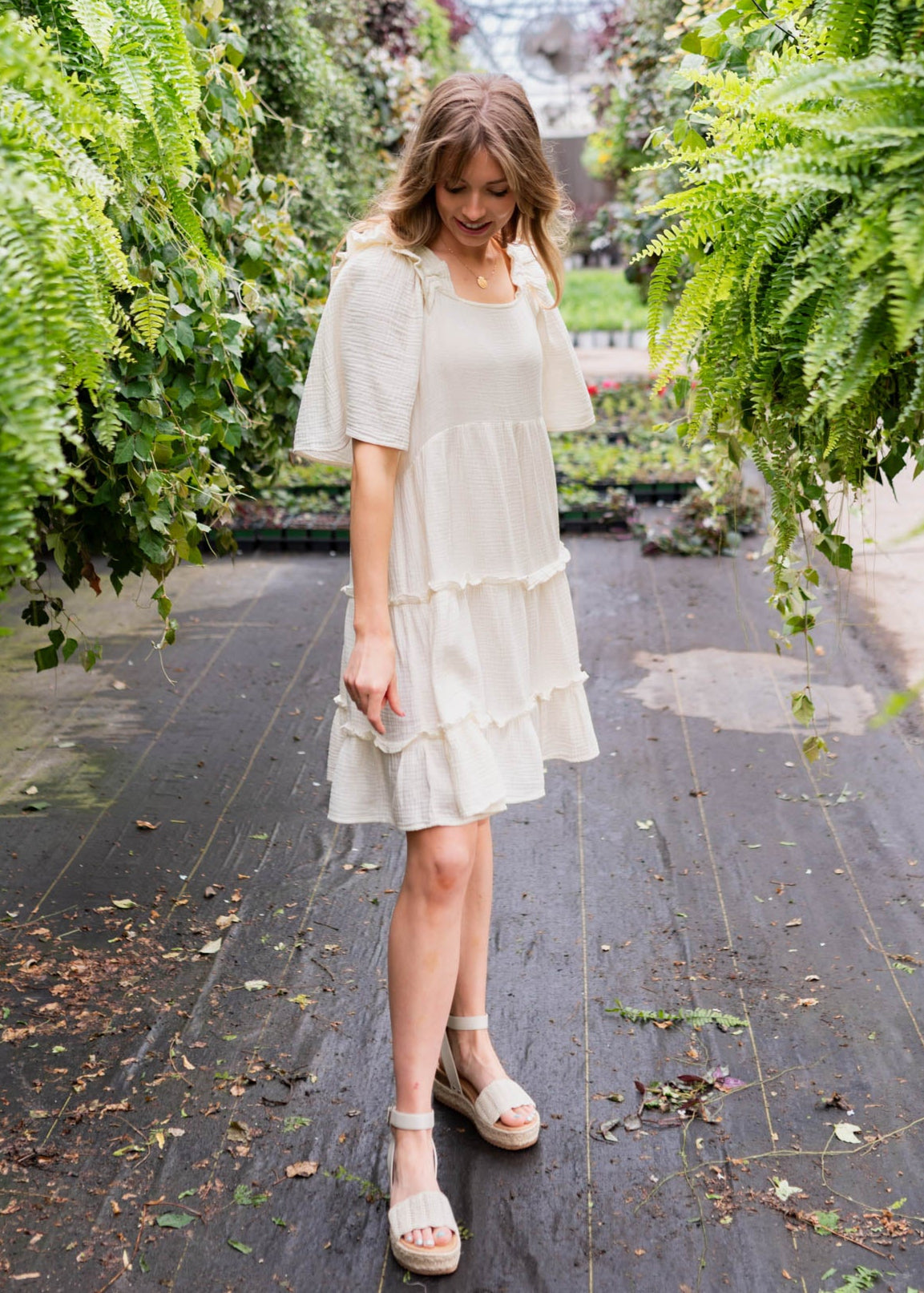 Ivory mini dress with ruffles at the neck