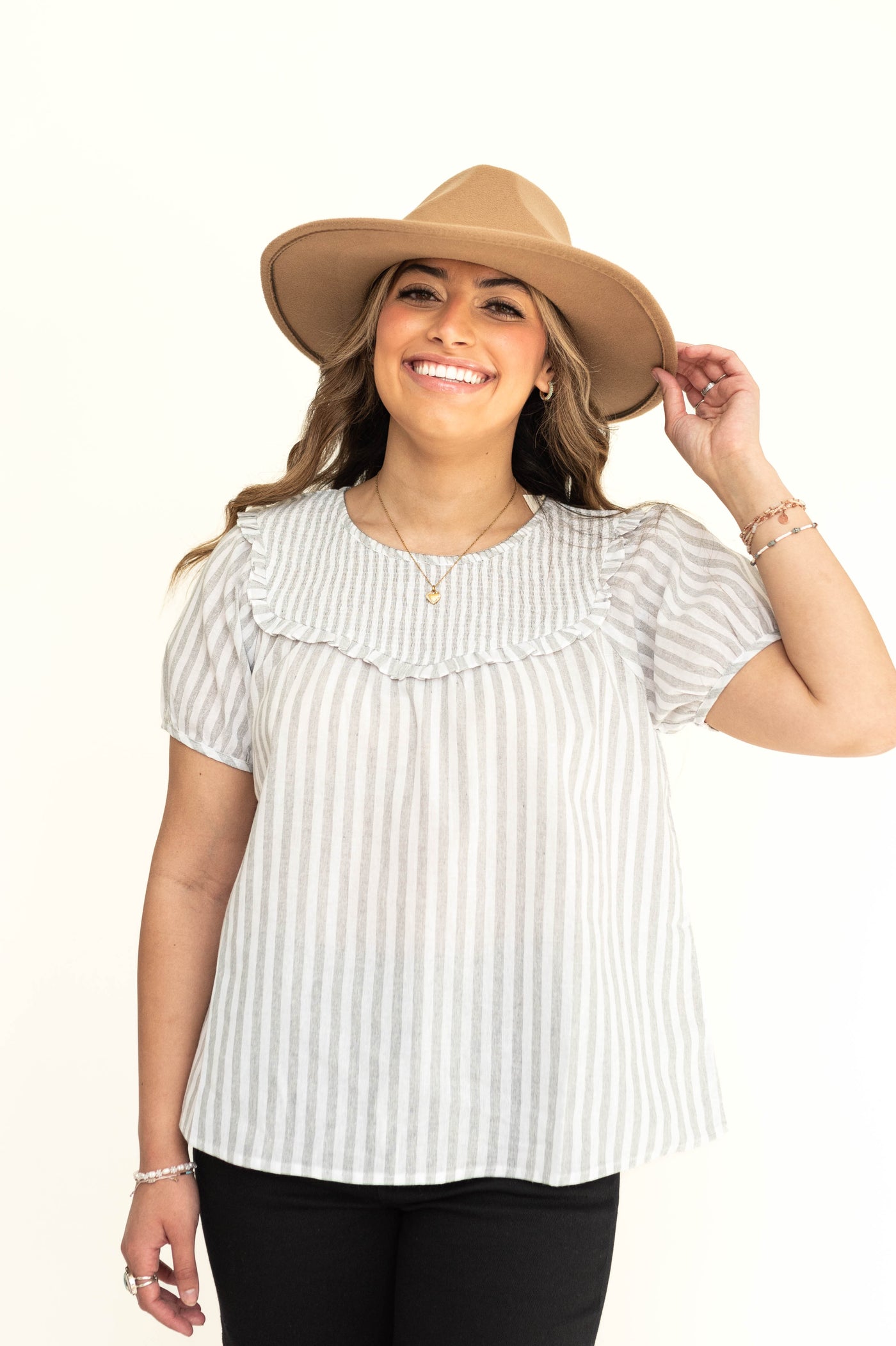 Front view of a short sleeve light gray and white stripe top.