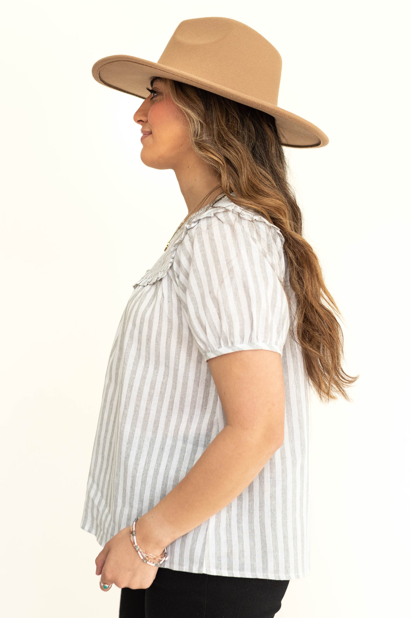 Side view of a short sleeve light gray and white stripe top.