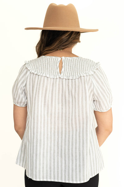Back view of a short sleeve light gray and white stripe top.
