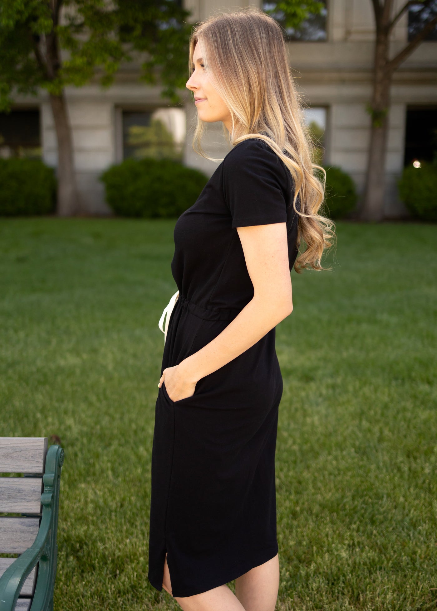Side view of a short sleeve knit black dress