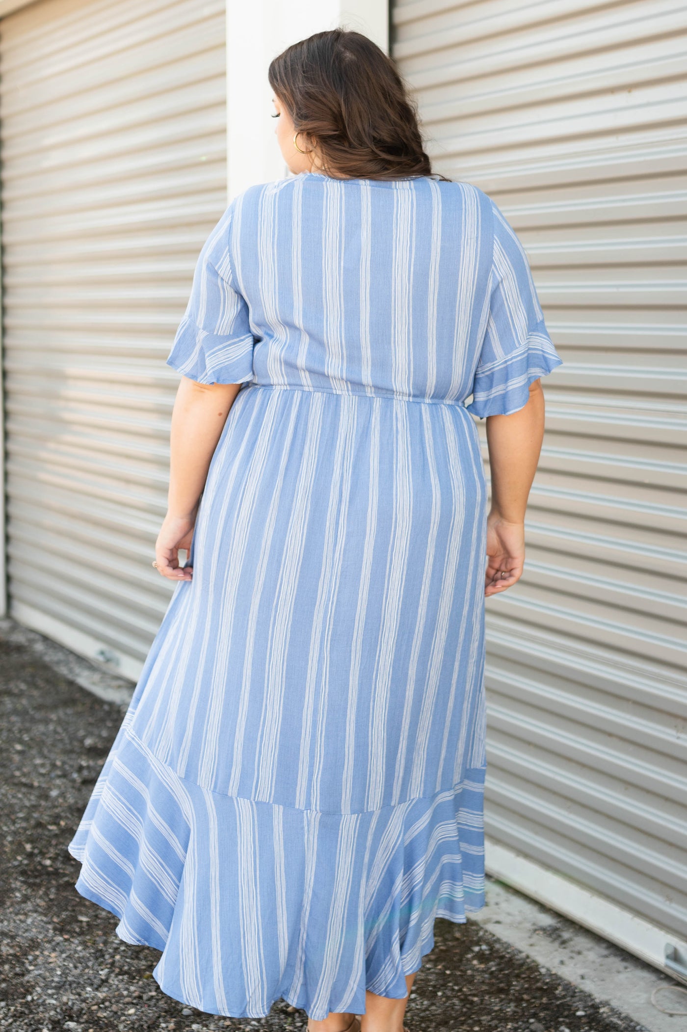Back view of a blue stripe plus size wrap dress