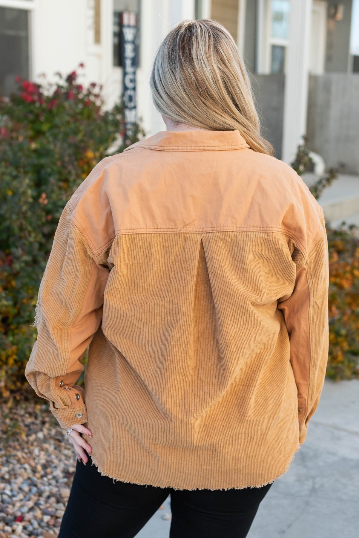 Back view of a plus size caramel shacket