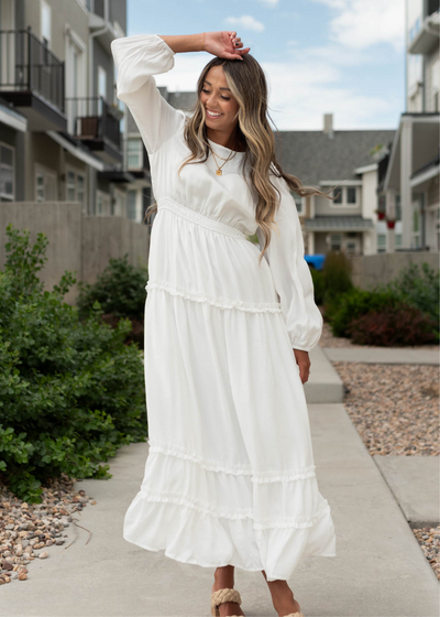 Long sleeve Chelsea white dress with teared skirt and ruffle at the bottom