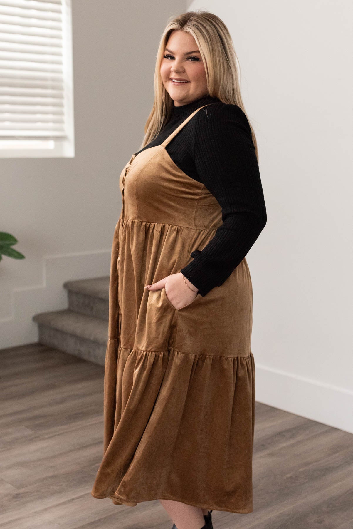 Side view of the plus size camel jumper dress with pockets