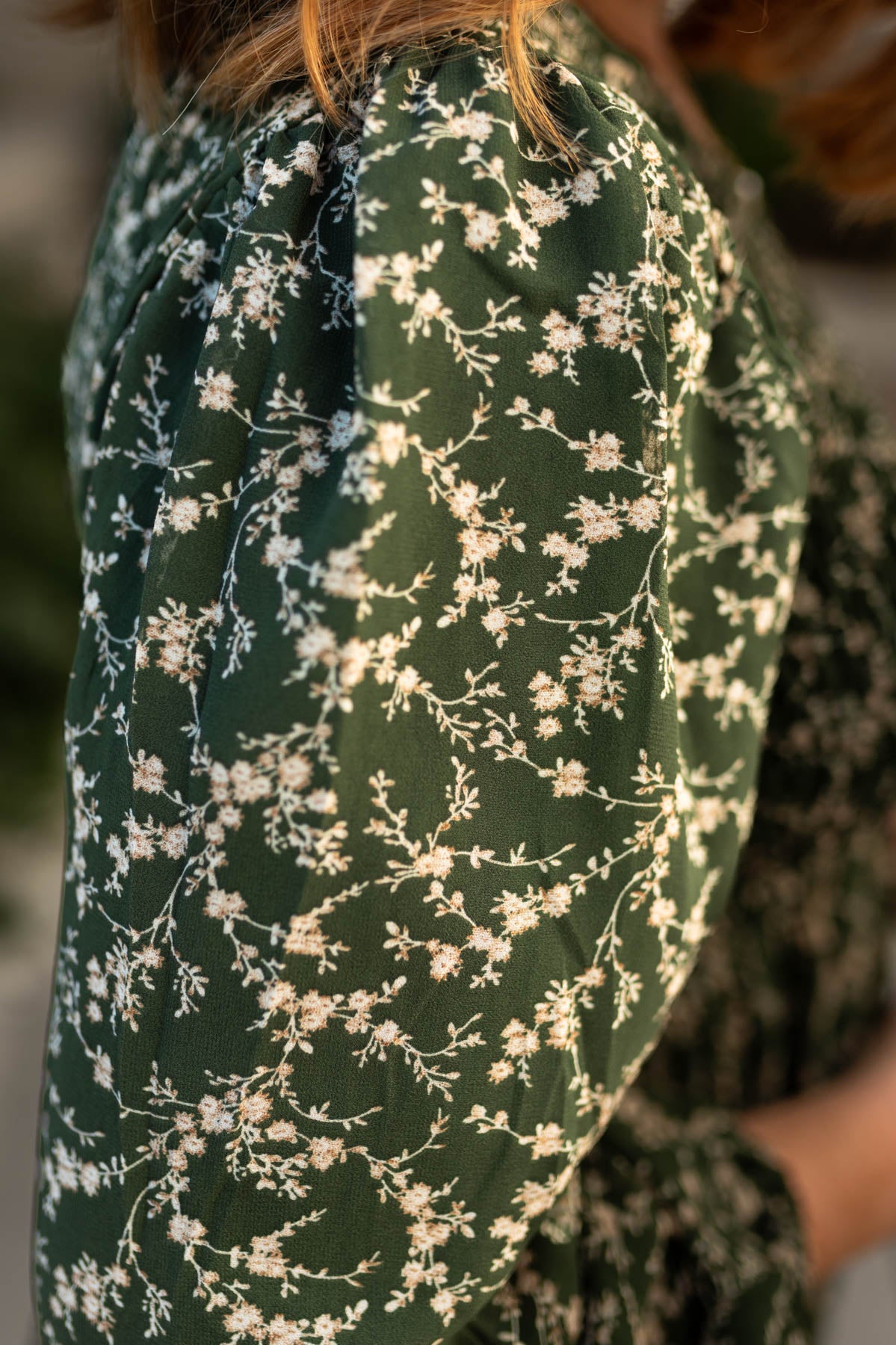 Floral pattern of a dark green dress