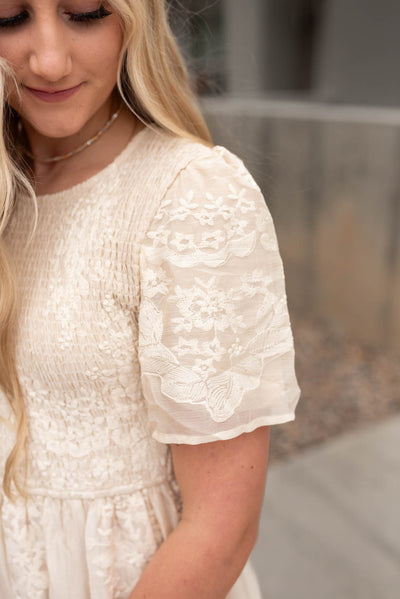 Sleeve on the champagne embroidered dress with smocked bodice
