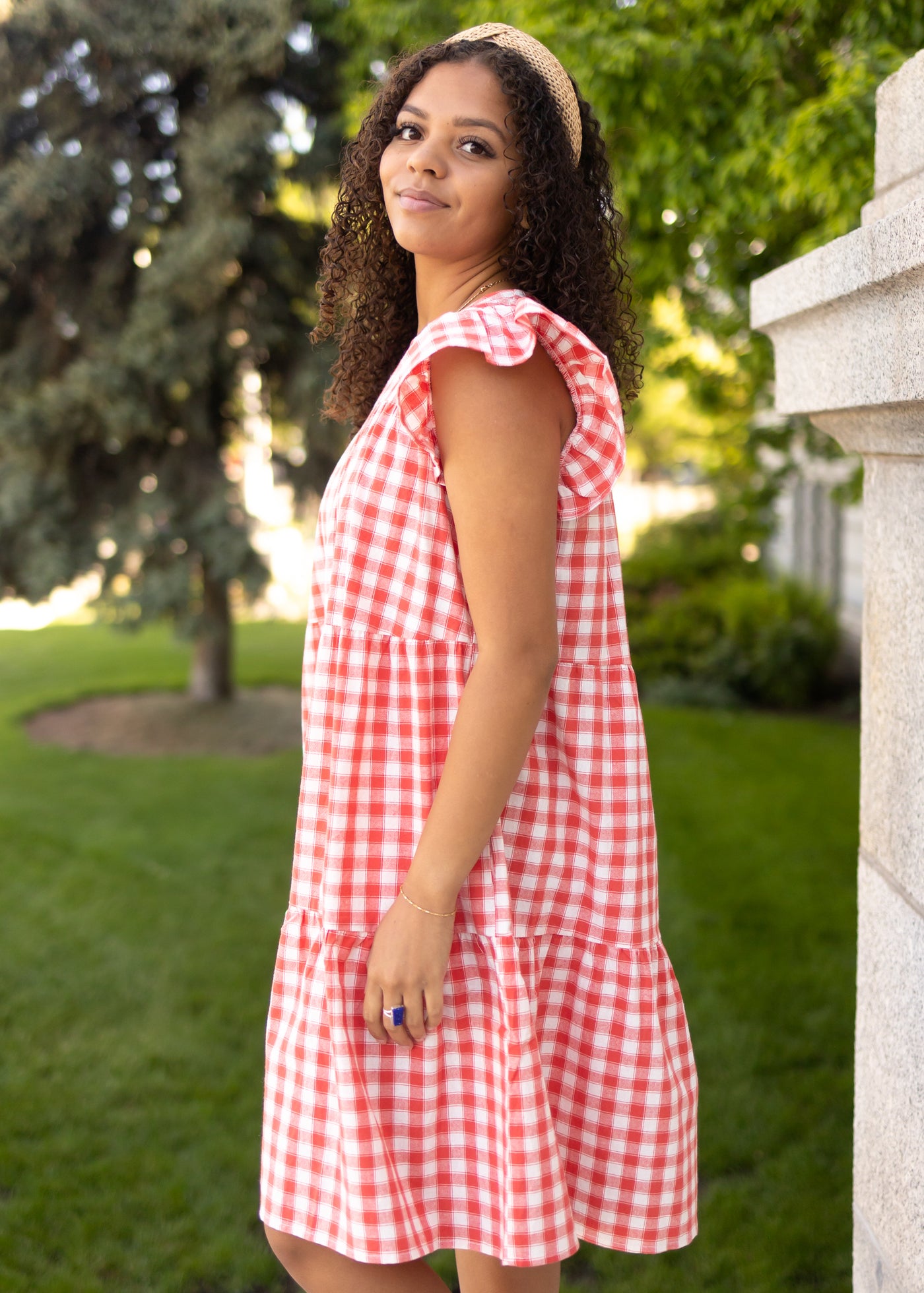 Side view of a red gingham dress with ruffle sleeves