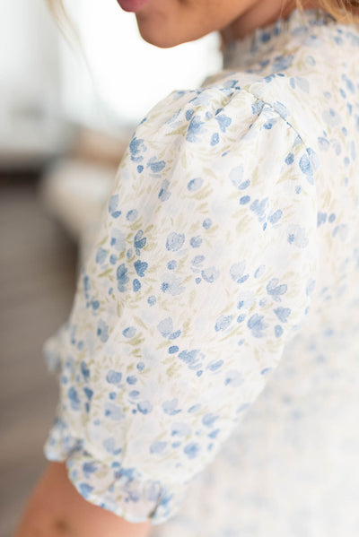Close up of the fabric on a blue ivory floral dress