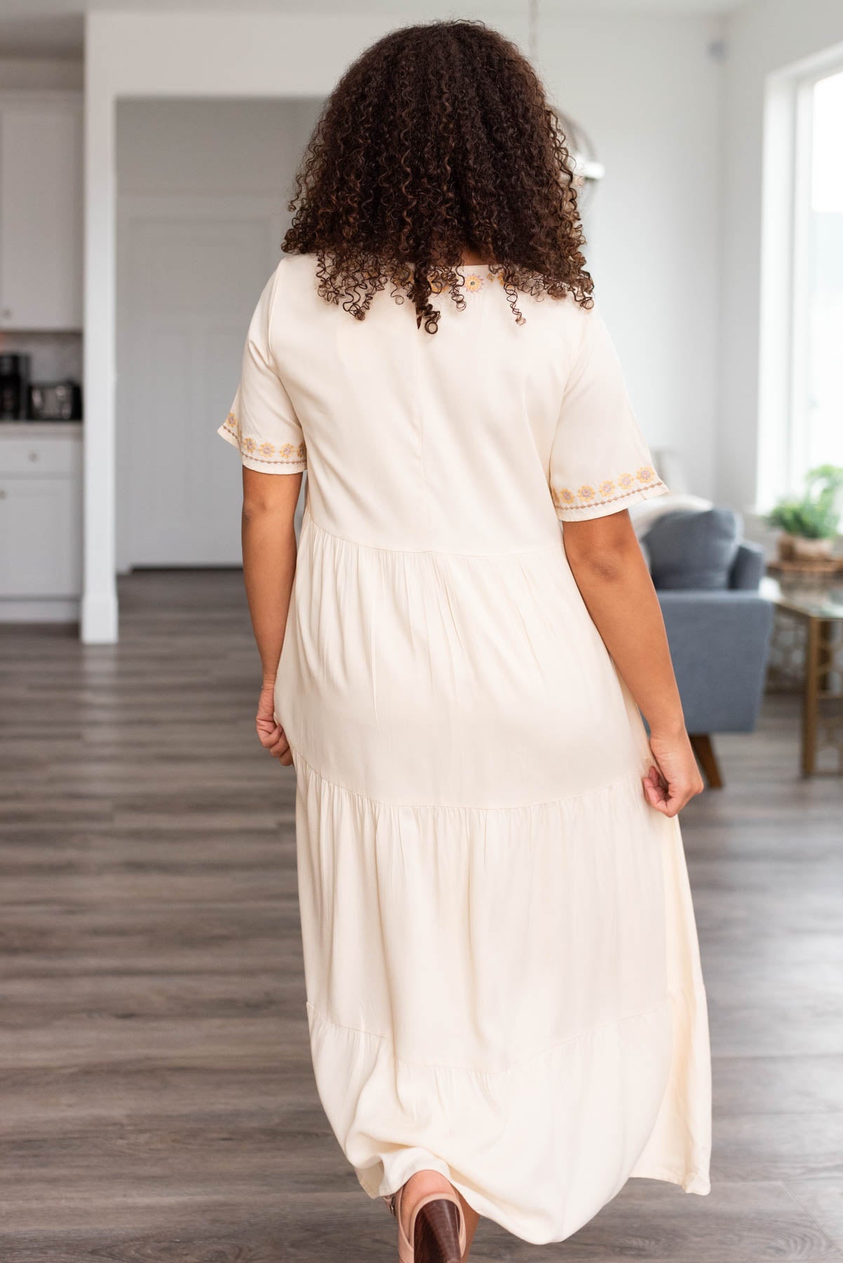 Back view of a tiered cream dress