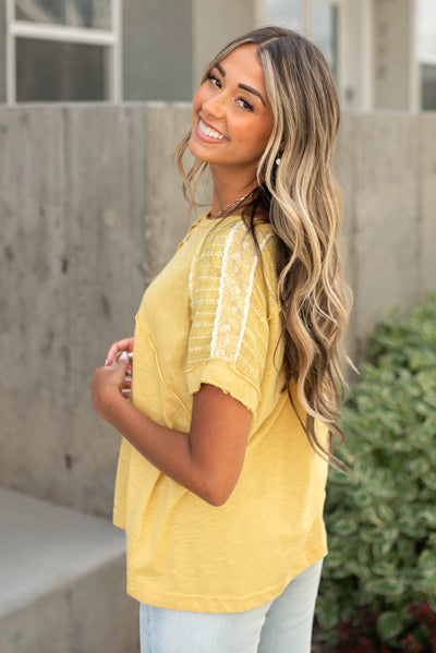 Side view of a short sleeve marigold top