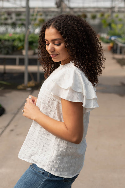 Side view of the white ruffle sleeve top