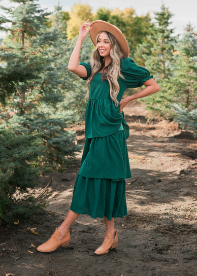 Side view of a green ruffle tiered dress with short sleeves