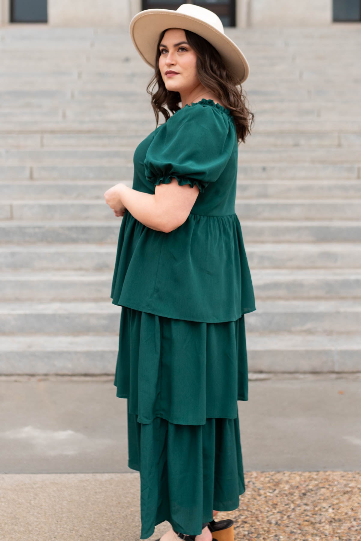 Side view of a plus size green ruffle tiered dress