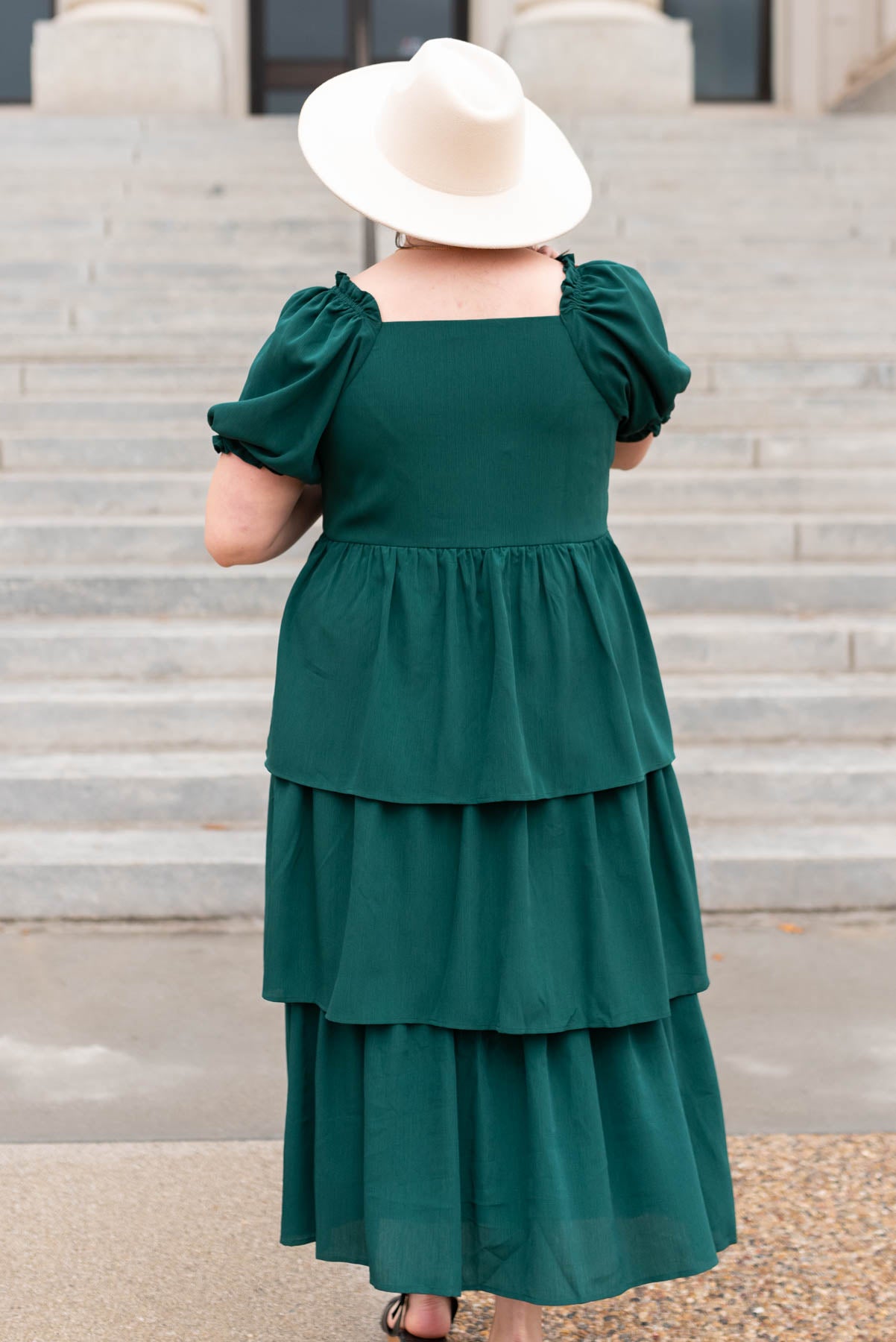 Back view of a green ruffle tiered dress