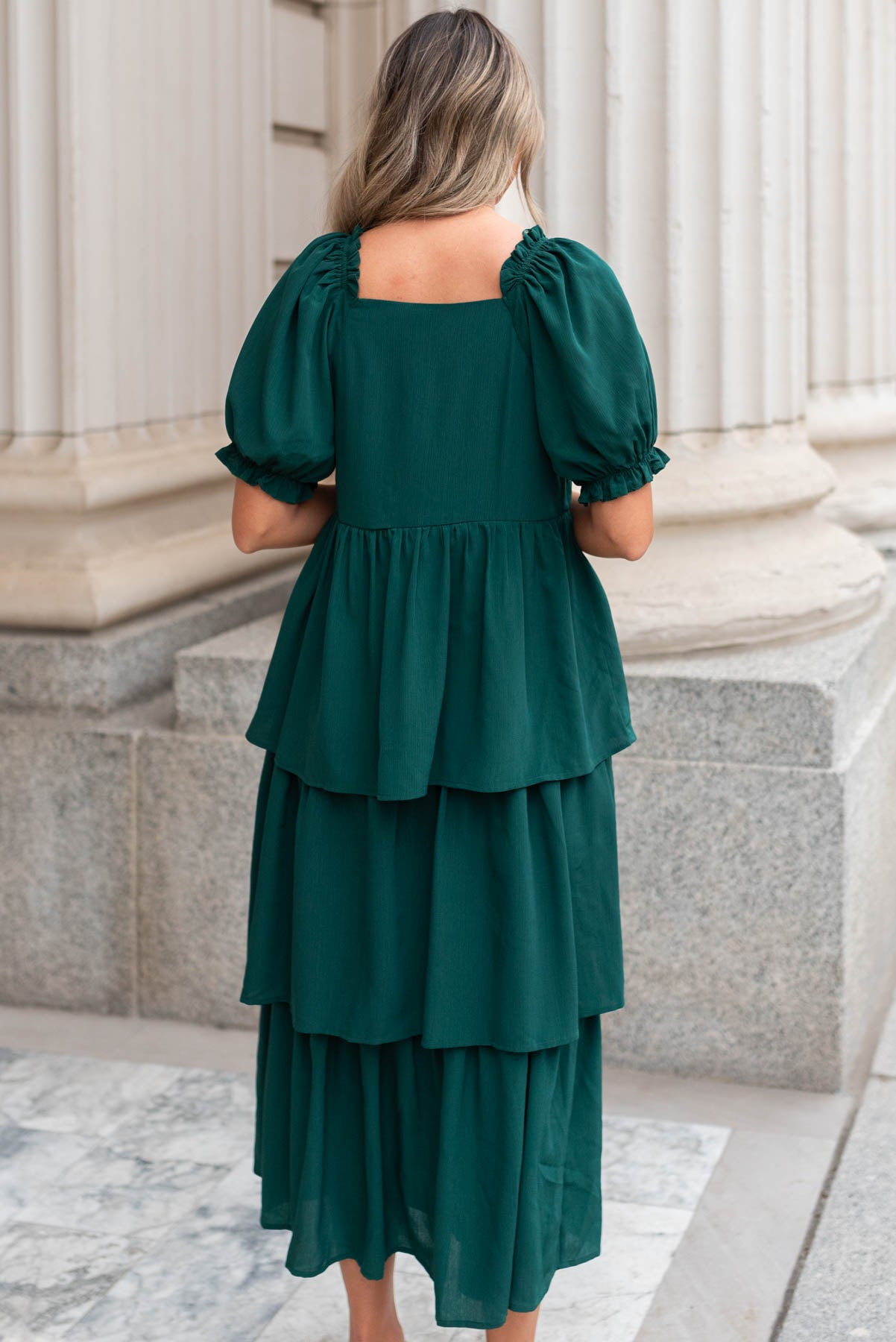 Back view of a green ruffle tiered dress