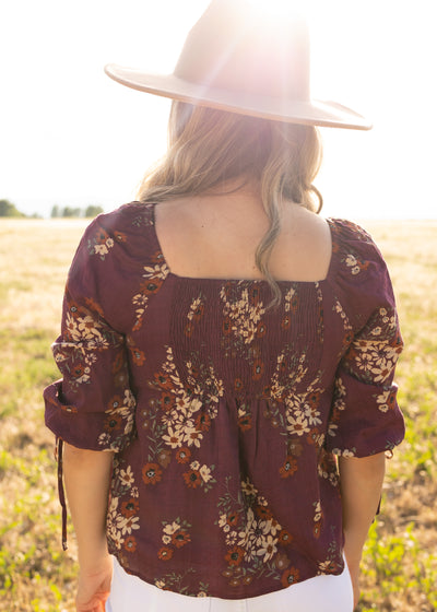 Back view of a plum floral top