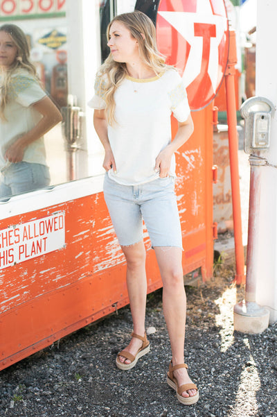 Front view of a knit white stripe top